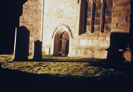 Nighttime photo of the exterior of Cartmel Priory, Cumbria