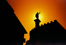 Photo of a statue in Firenze (Florence) taken against a burning red sky