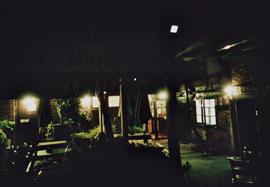 Nighttime photo of the exterior of The White Horse pub, Rogate